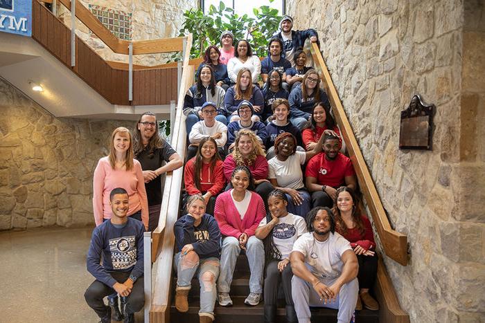 Resident assistants stand on Perkins Student Center stairs for photo